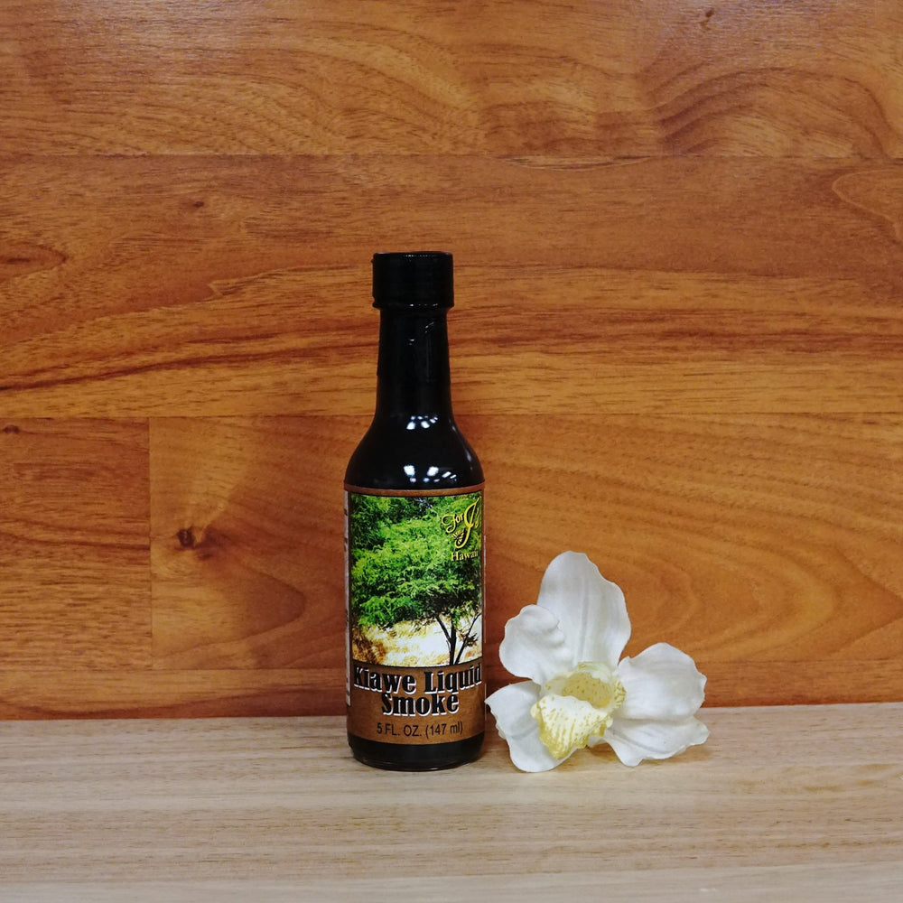 5 oz. Kiawe Liquid Smoke on a wooden background.