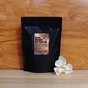 
                  
                    14 oz. Red 'Alaea Hawaiian Chili Pepper Sea Salt on a wooden background.
                  
                