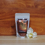 7 oz. Red 'Alaea Hawaiian Chili Pepper Sea Salt on a wooden background.