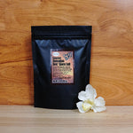 14 oz. Red 'Alaea Maui Onion Sea Salt on a wooden background.